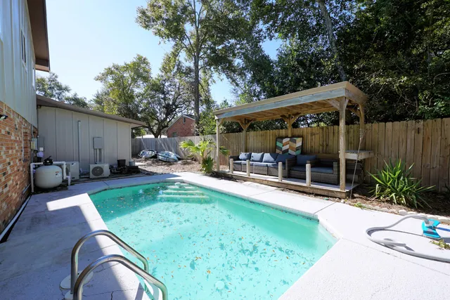 a view of a backyard with sitting area and slide