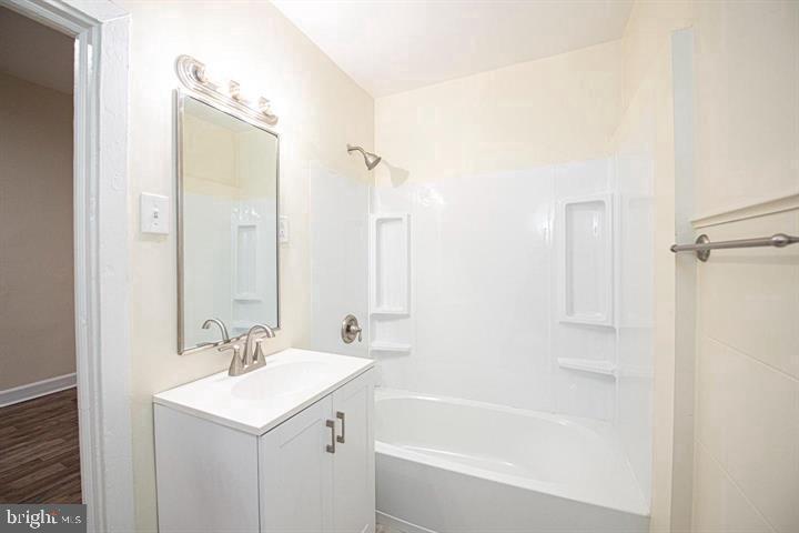 215 Bridge Street, Unit B Phoenixville, PA 19460 - Photo 12 of 31 a bathroom with a bath tub sink mirror and a shower