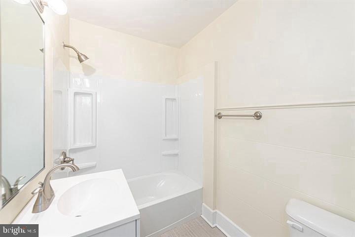 215 Bridge Street, Unit B Phoenixville, PA 19460 - Photo 13 of 31 a bathroom with a sink a toilet and shower