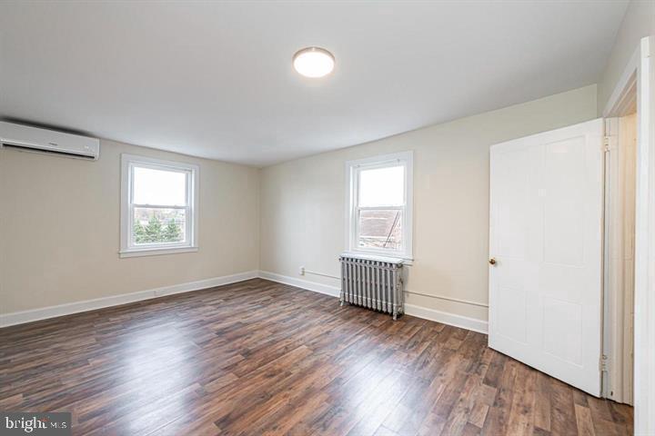 215 Bridge Street, Unit B Phoenixville, PA 19460 - Photo 15 of 31 an empty room with wooden floor cabinet and windows