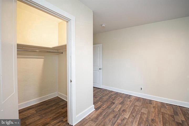 215 Bridge Street, Unit B Phoenixville, PA 19460 - Photo 19 of 31 a view of an empty room with wooden floor and a window
