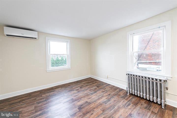 215 Bridge Street, Unit B Phoenixville, PA 19460 - Photo 21 of 31 an empty room with wooden floor and windows