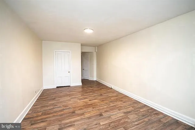 a view of an empty room and wooden floor