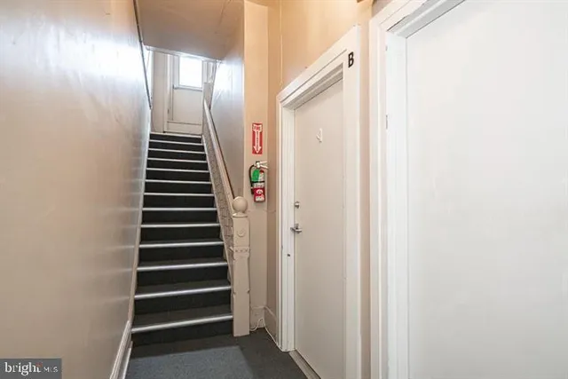 a view of a hallway with stairs and a window