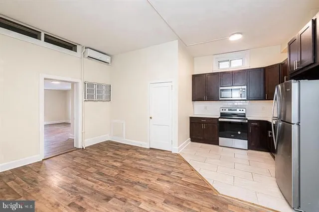 a kitchen with granite countertop a refrigerator and a sink