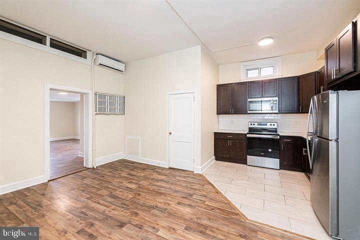 215 Bridge Street, Unit B Phoenixville, PA 19460 - Photo 4 of 31 a kitchen with granite countertop a refrigerator and a sink
