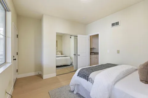 a bedroom with a bed and a window