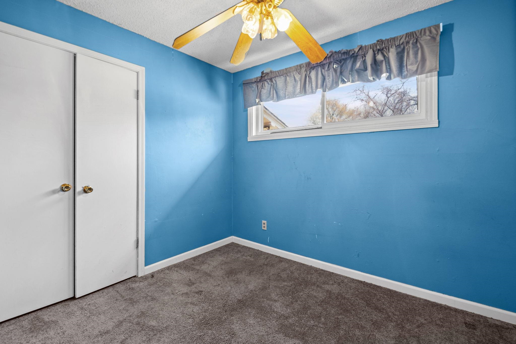 668 Westview Road Memphis, TN 38109 - Photo 16 of 27 Unfurnished bedroom featuring dark carpet, a closet, ceiling fan, and a textured ceiling