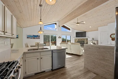 a kitchen with stainless steel appliances granite countertop a sink stove and wooden cabinets