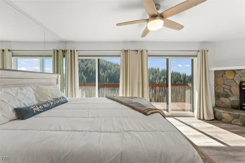 a bedroom with a large bed and a large window with outer view