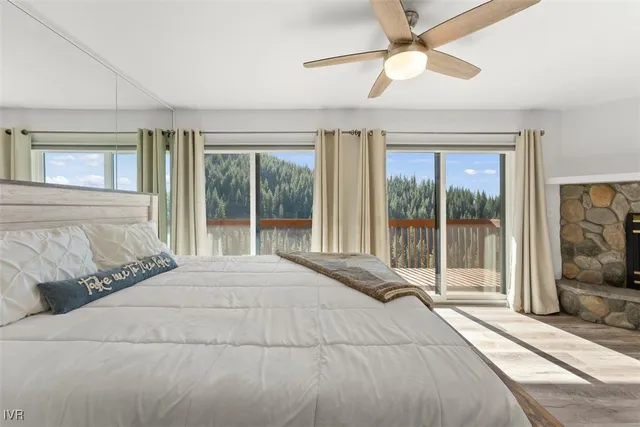 a bedroom with a large bed and a large window with outer view