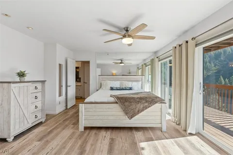 a bedroom with a large bed and a chandelier