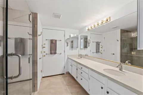 a spacious bathroom with a double vanity sink mirror and double