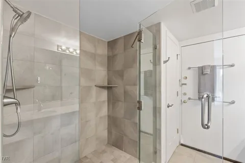 a bathroom that has a glass shower door