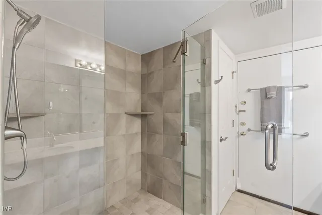 a bathroom that has a glass shower door