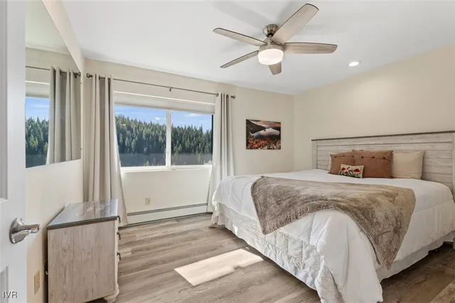 a bedroom with a large bed and a large window