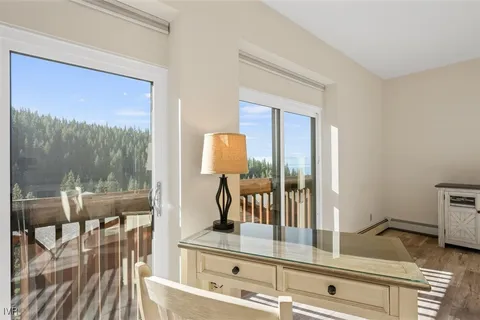 a view of living room with furniture and wooden floor