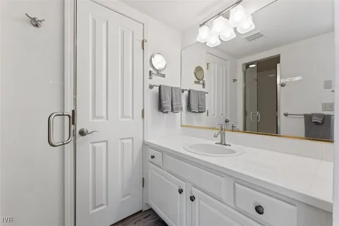 a bathroom with a double vanity sink and a mirror