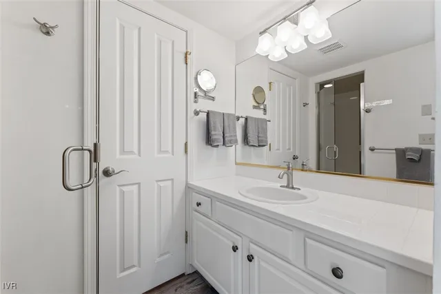 a bathroom with a double vanity sink and a mirror