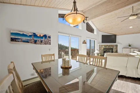 a view of a dining room with furniture a chandelier and wooden floor