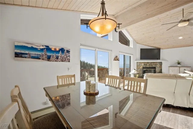 a view of a dining room with furniture a chandelier and wooden floor