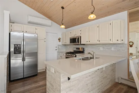 a kitchen with a refrigerator a sink and cabinets