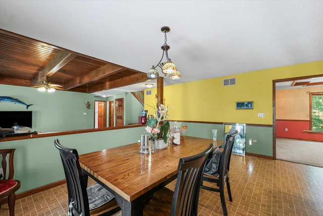 a kitchen with granite countertop a refrigerator and cabinets