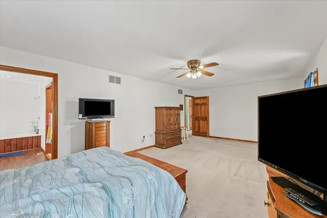 a green room with a window and a fan