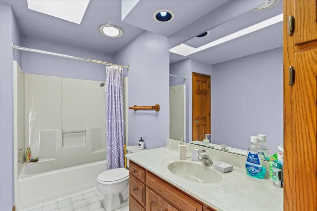 a bedroom with furniture and a fan