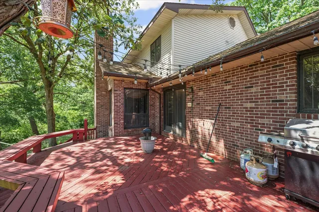 an aerial view of a house with a yard and lake view