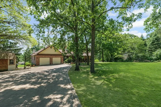 a front view of house with yard and green space