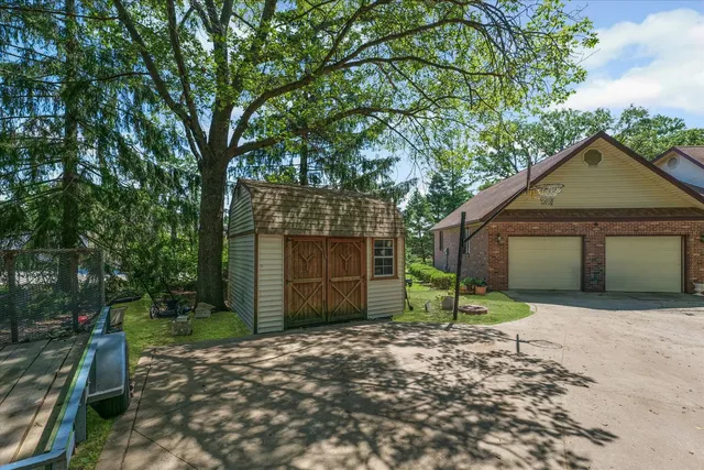 a view of a house with backyard and sitting area