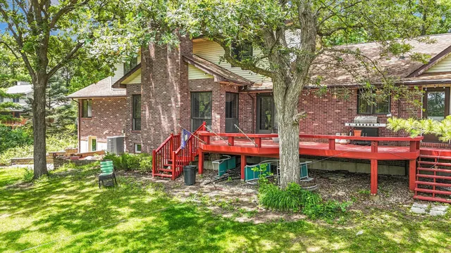 an aerial view of residential houses with outdoor space and trees