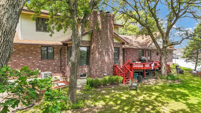 an aerial view of a house with a yard and lake view