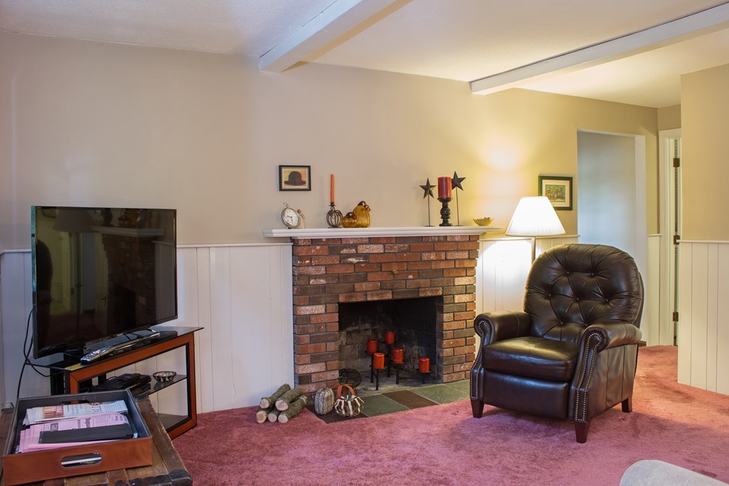 25 Green Valley Road Medway, MA 02053 - Photo 19 of 30 a living room with furniture a flat screen tv and a fireplace