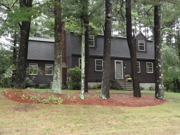 25 Green Valley Road Medway, MA 02053 - Photo 2 of 30 a view of a brick house next to a yard with large trees