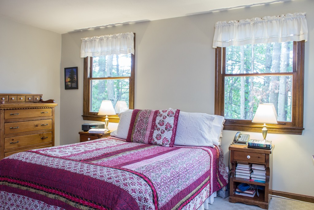 25 Green Valley Road Medway, MA 02053 - Photo 27 of 30 a bedroom with a bed and wooden floor