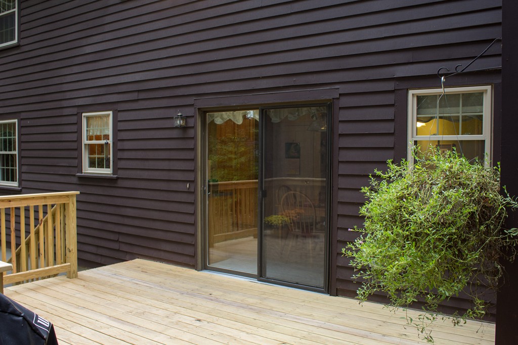 25 Green Valley Road Medway, MA 02053 - Photo 7 of 30 a backyard of a house with wooden floor and potted plants