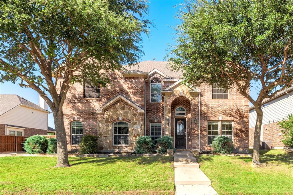 425 Windward Drive Murphy, TX 75094 - Photo 1 of 1 Traditional-style house with brick siding, a front lawn, and stone siding