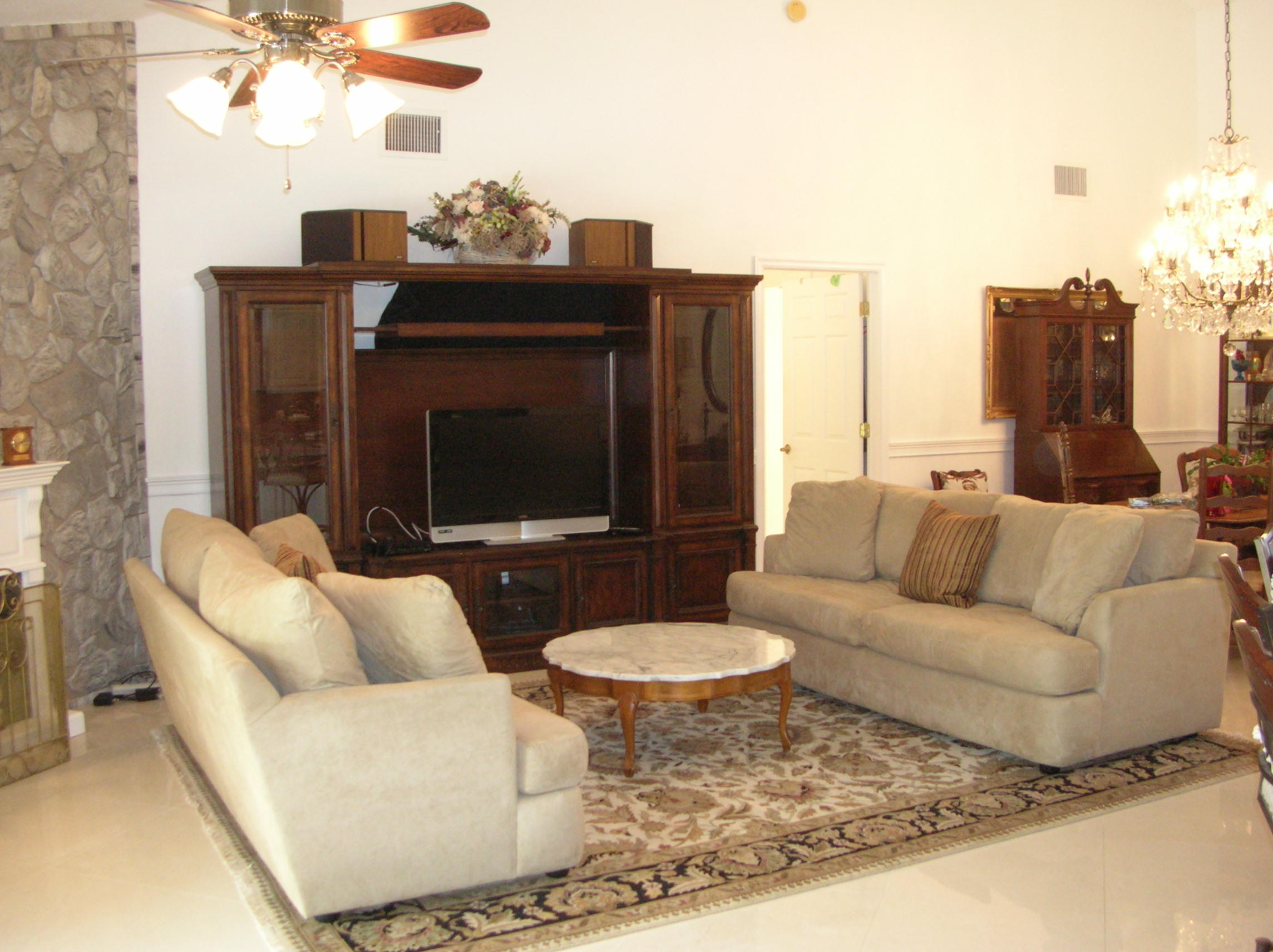 228 Northwest 69th Street Boca Raton, FL 33487 - Photo 14 of 31 a living room with furniture a fireplace and a chandelier