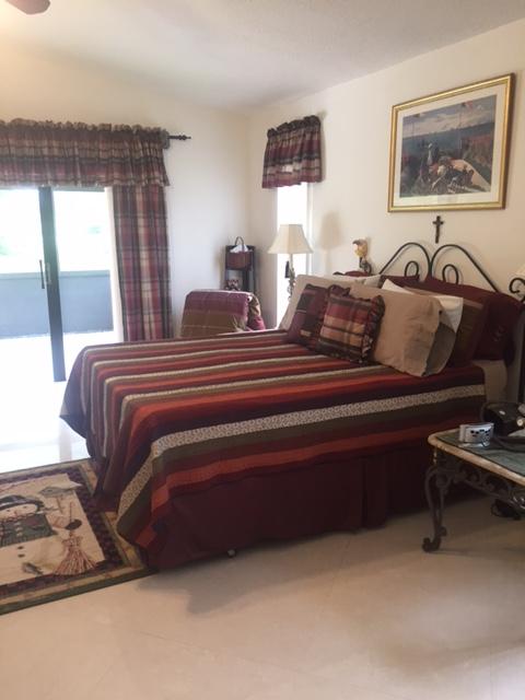 228 Northwest 69th Street Boca Raton, FL 33487 - Photo 16 of 31 a bedroom with bed and window