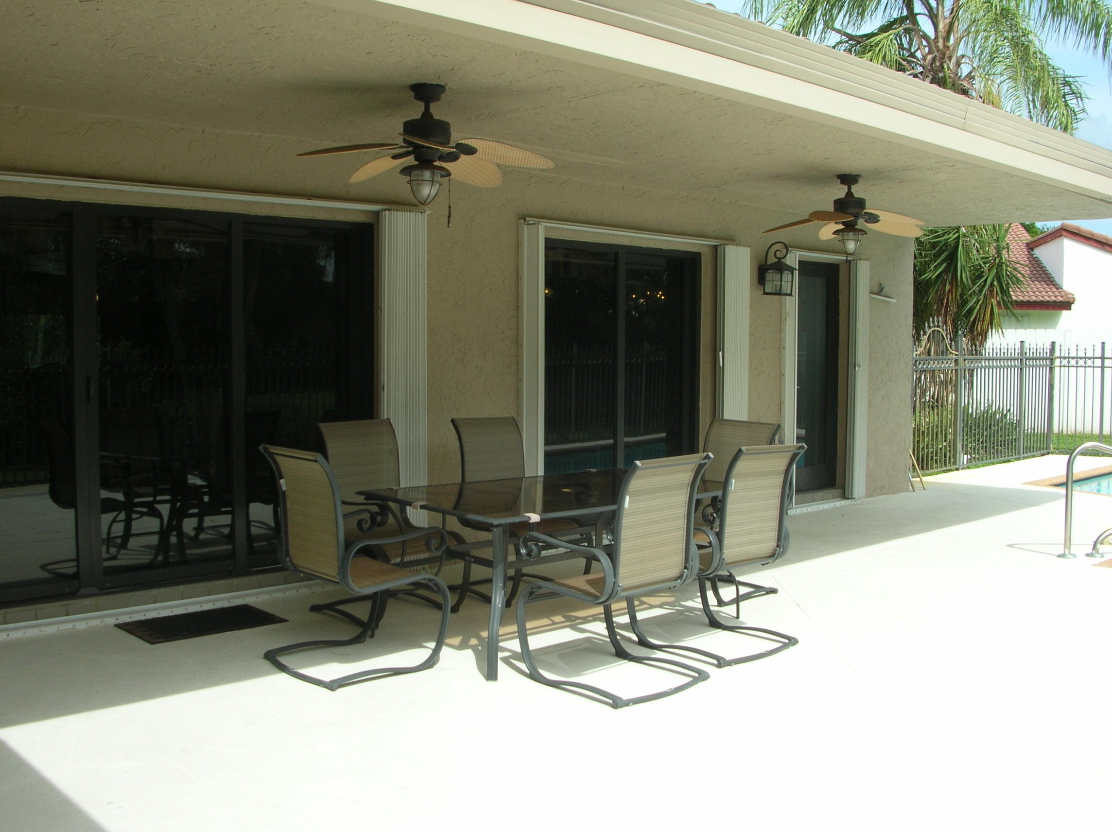 228 Northwest 69th Street Boca Raton, FL 33487 - Photo 27 of 31 a view of a chairs and tables in patio