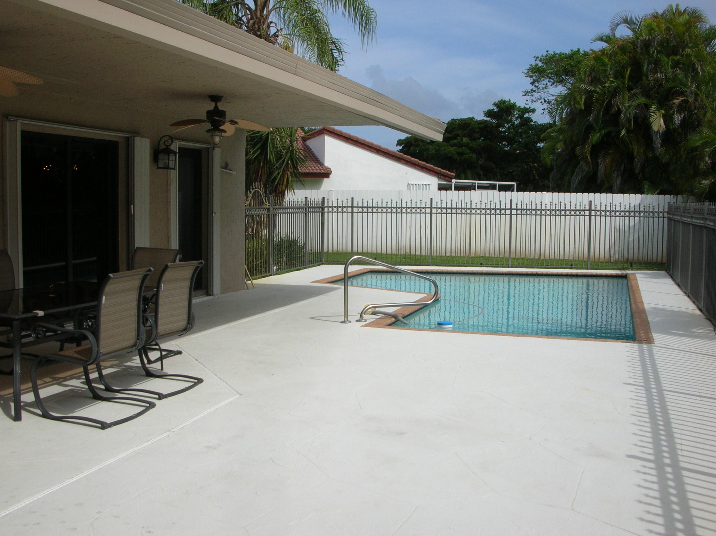 228 Northwest 69th Street Boca Raton, FL 33487 - Photo 28 of 31 a swimming pool with outdoor seating and yard