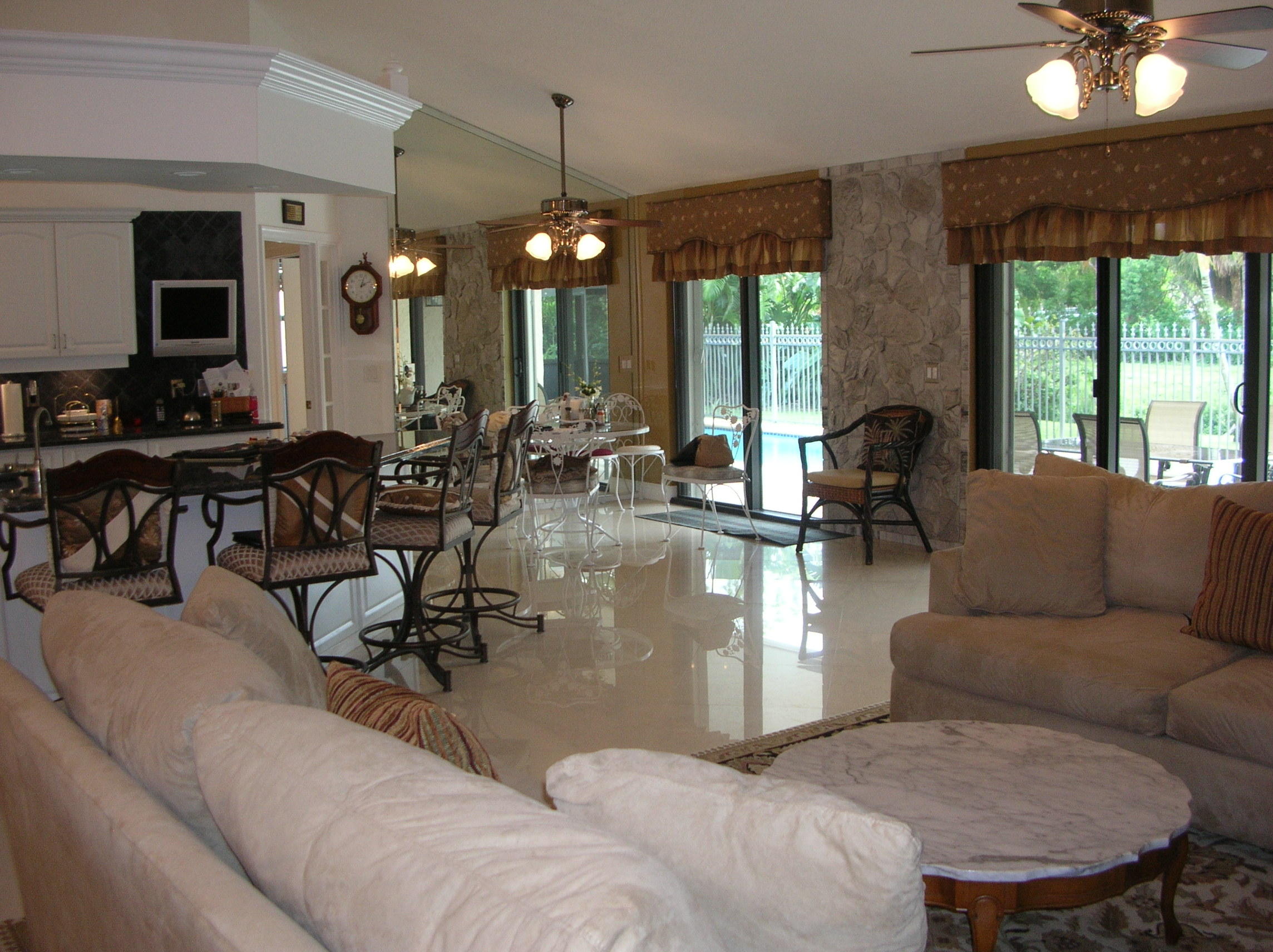 228 Northwest 69th Street Boca Raton, FL 33487 - Photo 4 of 31 a living room with couches a dining table and chairs with outer view