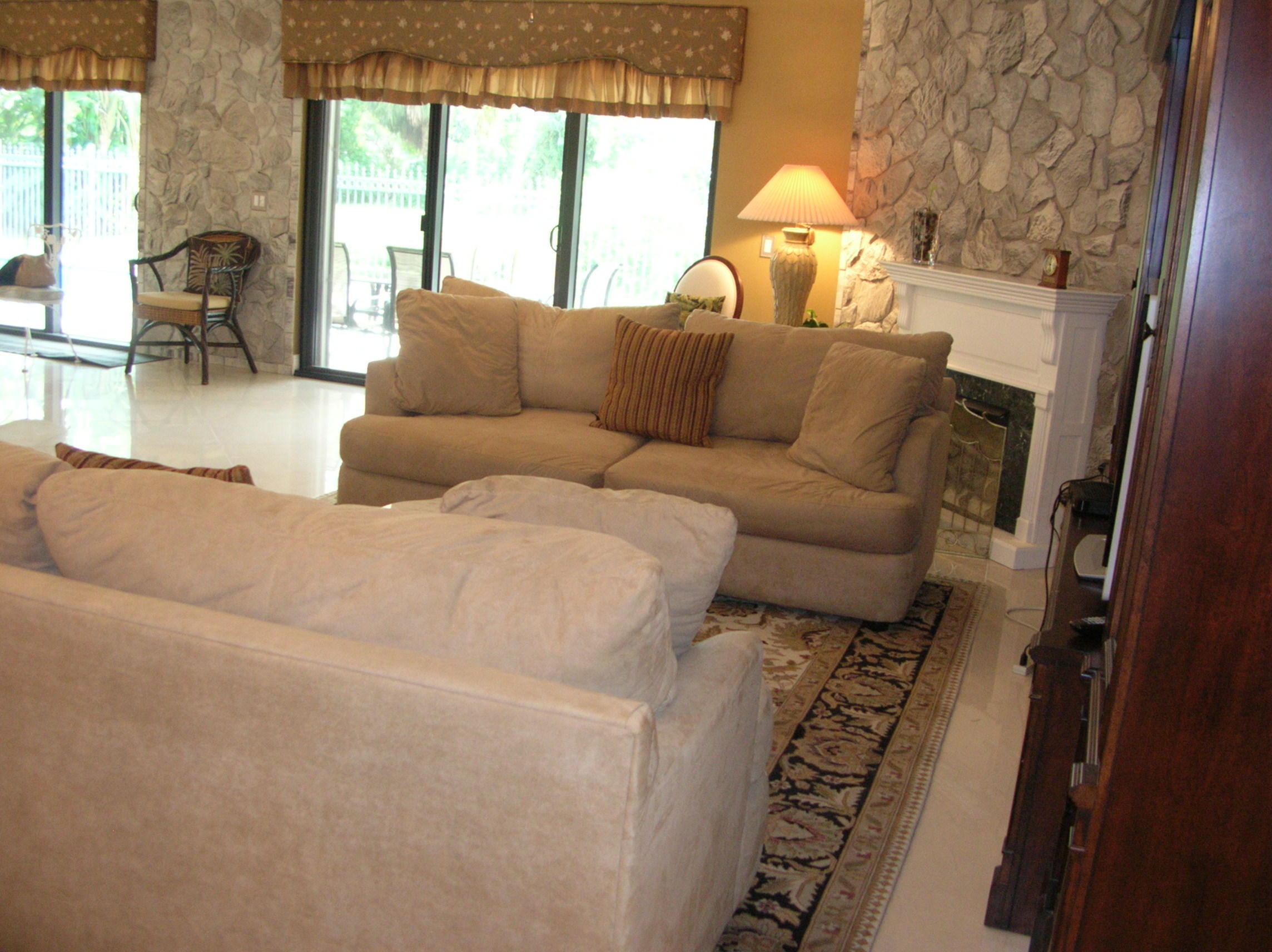 228 Northwest 69th Street Boca Raton, FL 33487 - Photo 5 of 31 a living room with furniture and a large window