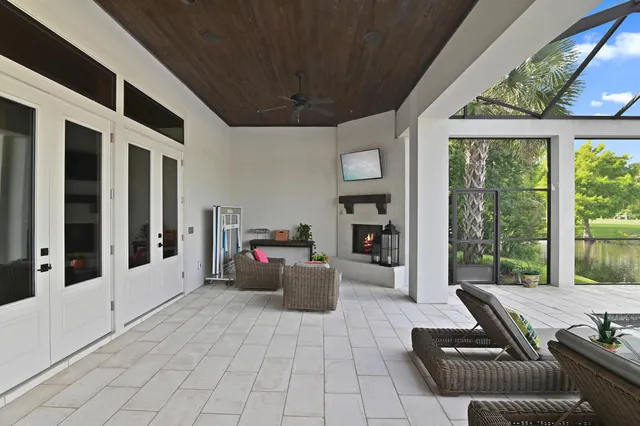 a living room with furniture and large windows