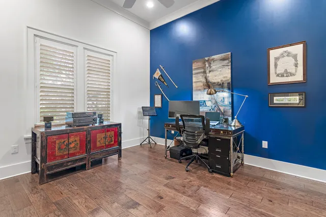 a view of a workspace with furniture and a book shelf