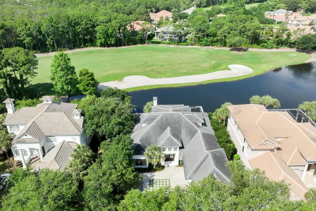 an aerial view of a house with outdoor space and lake view