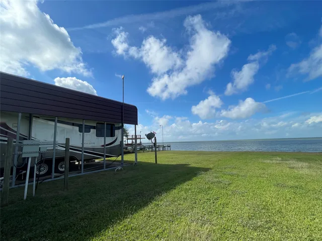 a view of a big yard with a table and chairs