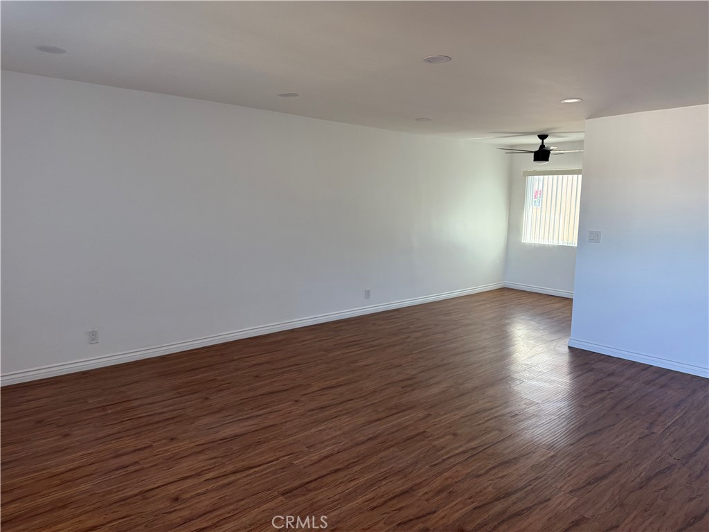 7159 Greeley Street, Unit F Tujunga, CA 91042 - Photo 15 of 15 a view of an empty room with wooden floor and a window